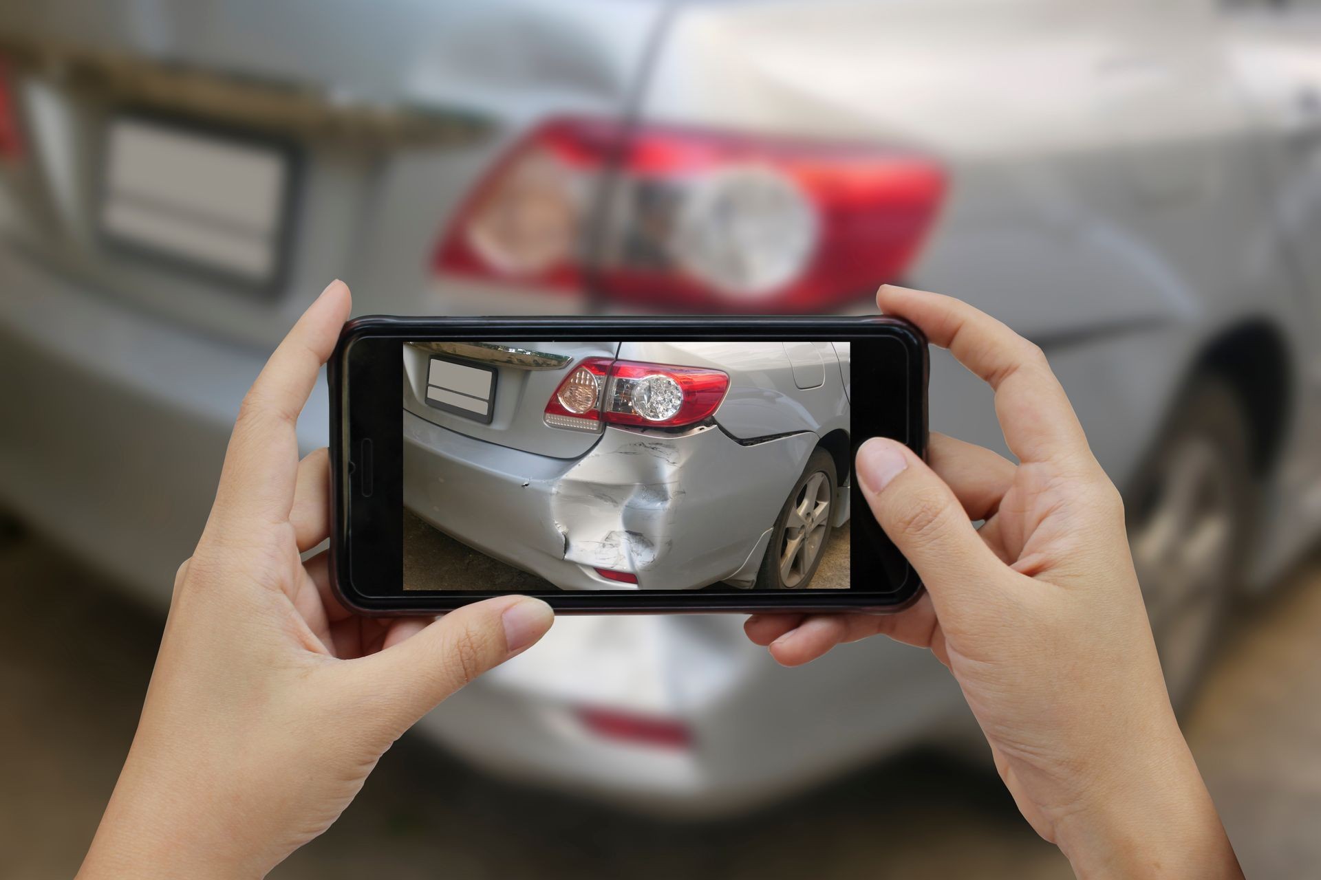 Close up hand holding smartphone and take photo at The scene of a car crash and accident, car accident for car insuranc claim. Close up hand holding smartphone and take photo at The scene of a car crash and accident, car accident for car insuranc claim.